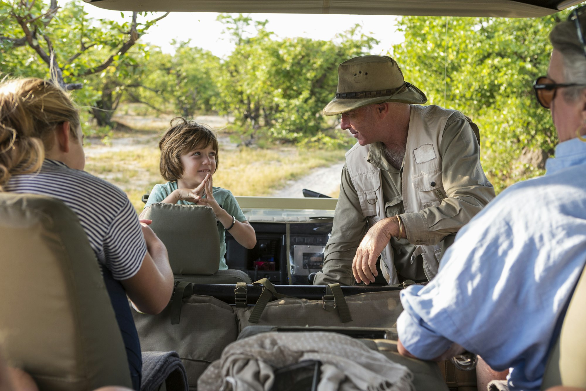 a-family-of-visitors-in-a-safari-vehicle-with-a-guide-